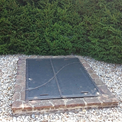 A wrought iron well cover