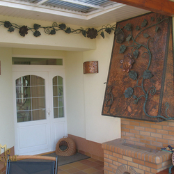 A wrought iron garden fireplace - Copper fireplace with a forged trailing sunflower A wrought iron garden fireplace - Copper fireplace with a forged trailing sunflower