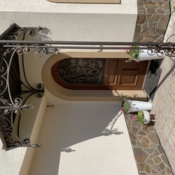 Wrought iron shelter with a romantic touch - entrance to the family house Wrought iron shelter with a romantic touch - entrance to the family house