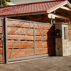 A wrought iron gate - wood - metal, harmony of materials