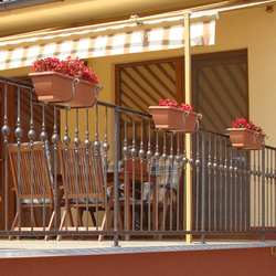 Wrought iron flower holders on the balcony Wrought iron flower holders on the balcony