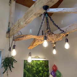 Adesigner wooden lighting on a forged chain  An orginal pendant lighting