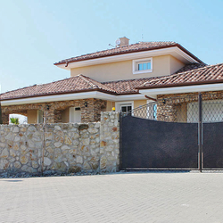 A wrought iron gate - metal plate and wrought iron combination