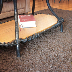 Coffee table in a family house, combination of wrought iron/oak wood