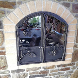 Hand-forged garden fireplace doors with grape motif Hand-forged garden fireplace doors with grape motif
