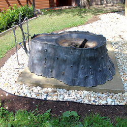 Artistic fireplace forged as a stump of a tree with oak fireplace tools Artistic fireplace forged as a stump of a tree with oak fireplace tools