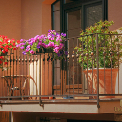 Wrought iron pot holders on the balcony Wrought iron pot holders on the balcony