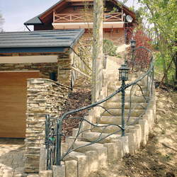 An exterior railing with a lamp - a cottage by the forrest