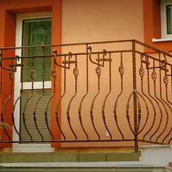 Wrought iron flower holders on the balcony Wrought iron flower holders on the balcony