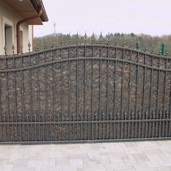 A wrought iron gate with metal