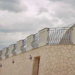 A wrought-iron railing on the terrace by the pool  a family villa