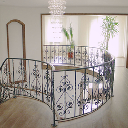 A curved wrought iron railing - interior railing