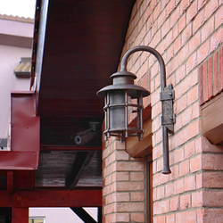 A hand wrought iron lamp with a shade A hand wrought iron lamp with a shade