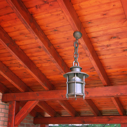 A wrought iron hanging light with a shade A wrought iron hanging light with a shade