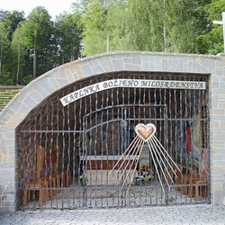 A wrought iron grille on a chapel of Gods mercy with stainless steel and copper wrought heart