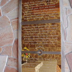 A golden plated board with a prayer in the brushed stainless steel frame in the pilgrimage place A golden plated board with a prayer in the brushed stainless steel frame in the pilgrimage place