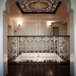 Luxury wrought iron railing with wooden handrail in the gallery of a family house Luxury wrought iron railing with wooden handrail in the gallery of a family house