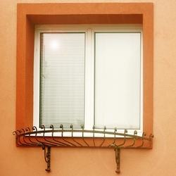 Forged flower holder on a family home window Forged flower holder on a family home window