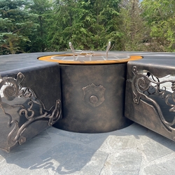 Hand-forged fire pit with grill and wood storage space Hand-forged fire pit with grill and wood storage space