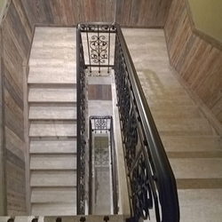 View of the stair railing from above - forged railing in the interior of the pension View of the stair railing from above - forged railing in the interior of the pension