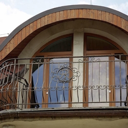 A wrought iron railing with a logo