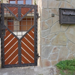 A modern gate - wood - metal, harmony of materials - A wrought iron gate