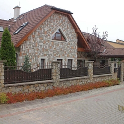 A wrought iron fence - metal plate and wrought iron combination