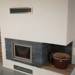 Modern interior fireplace completed with forged air intake covers Modern interior fireplace completed with forged air intake covers