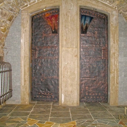 A wrought iron door in a wine cellar