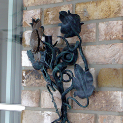 A wrought iron sunflower as a side lamp