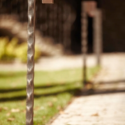 A wrought iron lamp stand for a garden