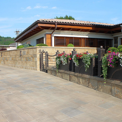 A wrought iron fence with flowerpots - A modern fence