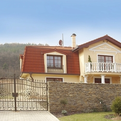 Vue d'ensemble d'une maison familiale – portail en fer forgé, portillon et grilles pour fenêtres Vue d'ensemble d'une maison familiale – portail en fer forgé, portillon et grilles pour fenêtres