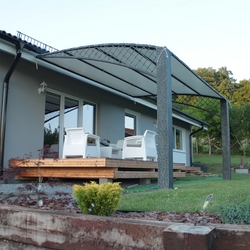 Wrought iron roofing of the terrace of a family house in a modern style Wrought iron roofing of the terrace of a family house in a modern style