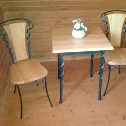 Forged table and chairs as part of the furniture in the room of the ari pension