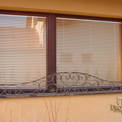 A wrought iron flower holder for a window A wrought iron flower holder for a window
