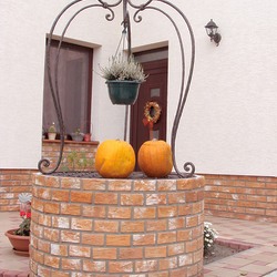 A wrought iron dome above a well