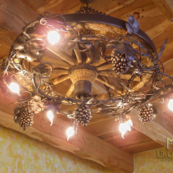 Artistic chandelier Vigne in the wagon wheel - hand-forged lighting designed for wine cellars, restaurants, gazebos, cottages...