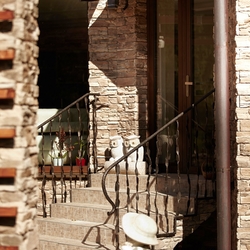 Copper shelter and crazy railings at the entrance to the family house