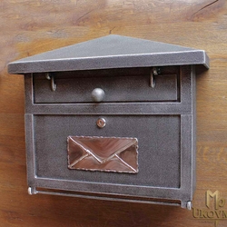 A wrought iron post box