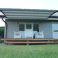 Wrought iron roofing of the terrace of a family house in a modern style Wrought iron roofing of the terrace of a family house in a modern style