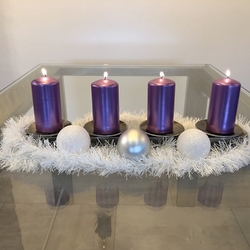 Aforged Advent candle holder with a simple design  aChristmas candle holder with nails for the fixing of candles