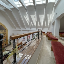 Wrought iron railing with wooden handrail on the gallery of the church Wrought iron railing with wooden handrail on the gallery of the church